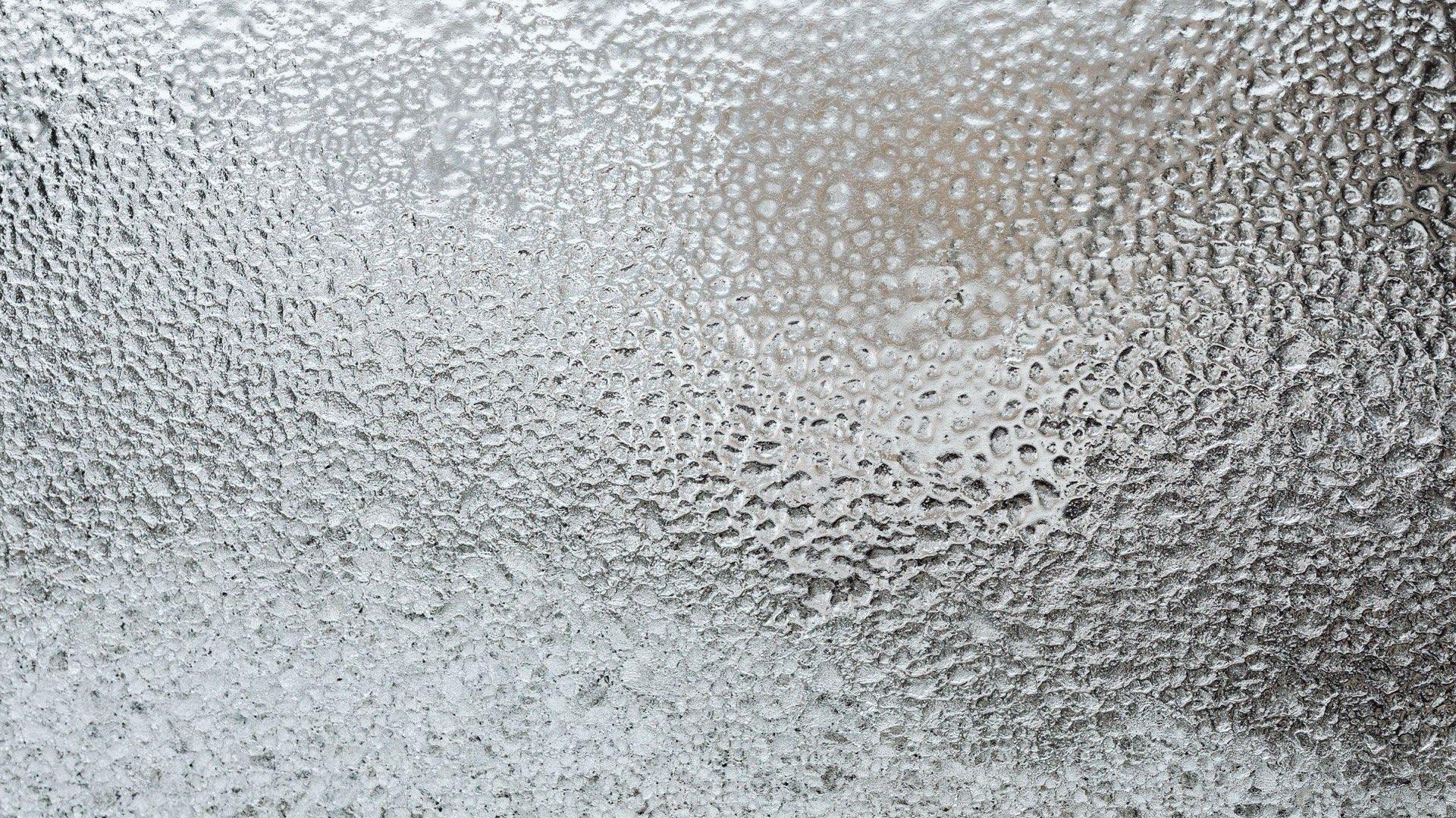 A frosted glass pane, lit from behind, with nothing readable through it.